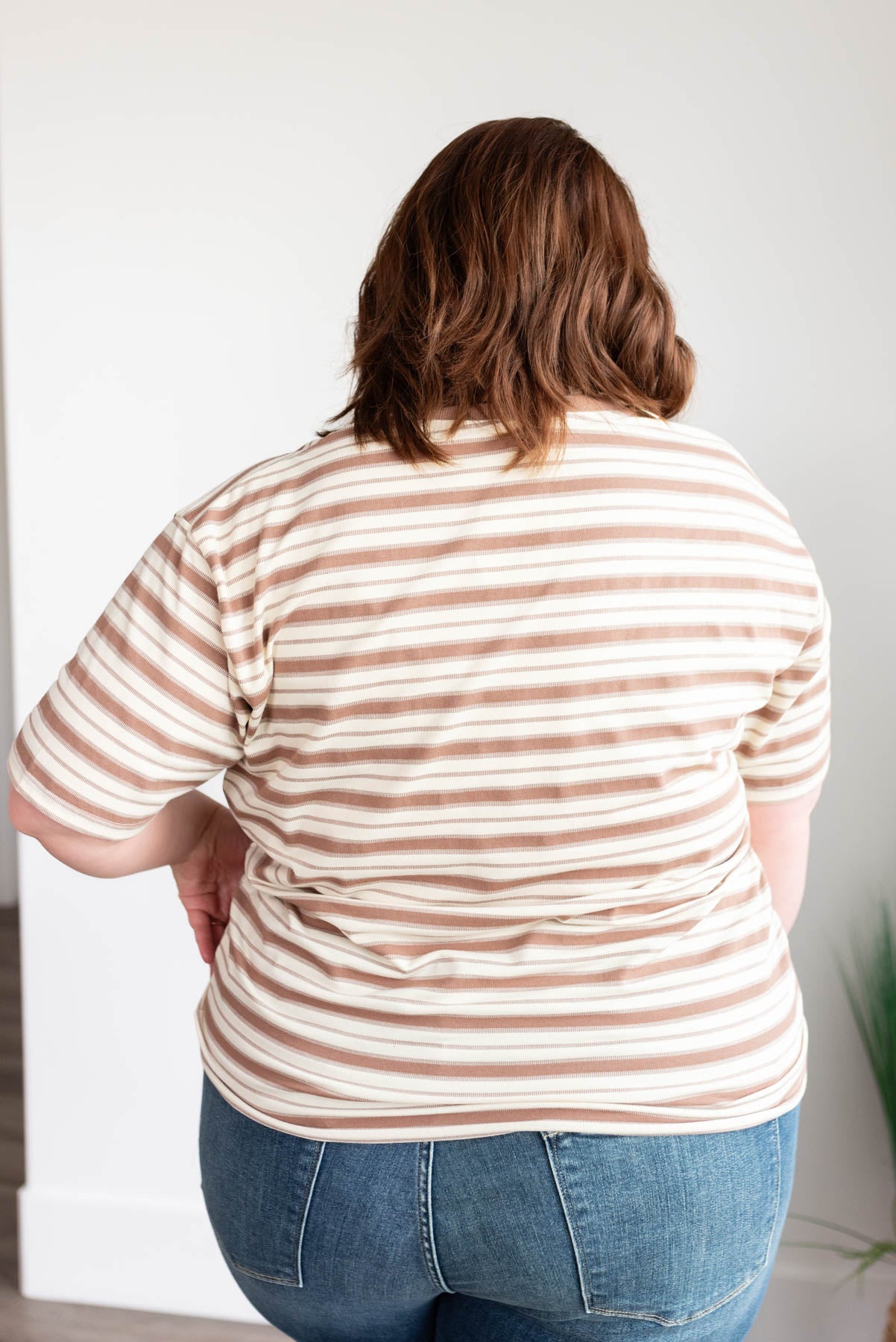 Back view of the taupe stripe top in plus size