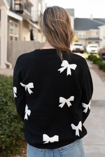 Back view of the black bow sweater