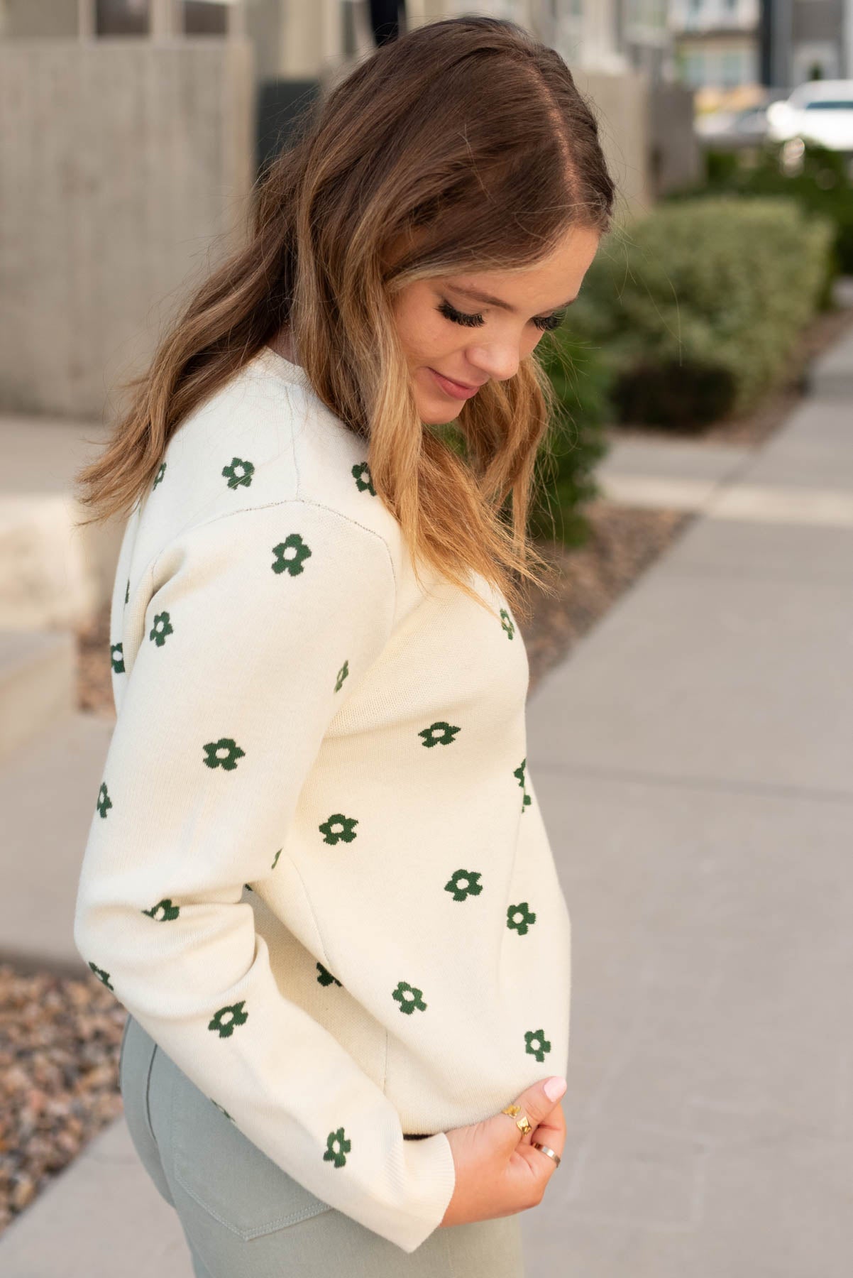 Side view of the cream green floral sweater