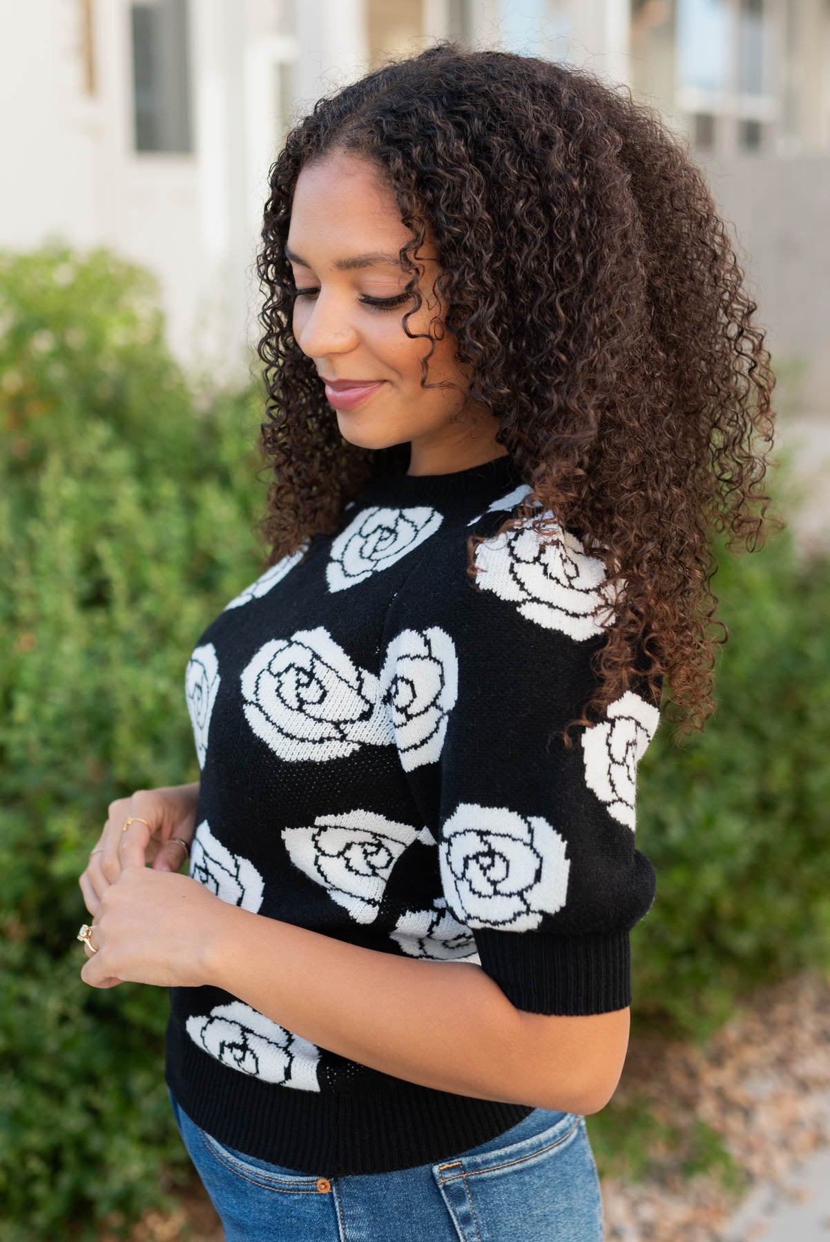 Side view of the black floral print sweater