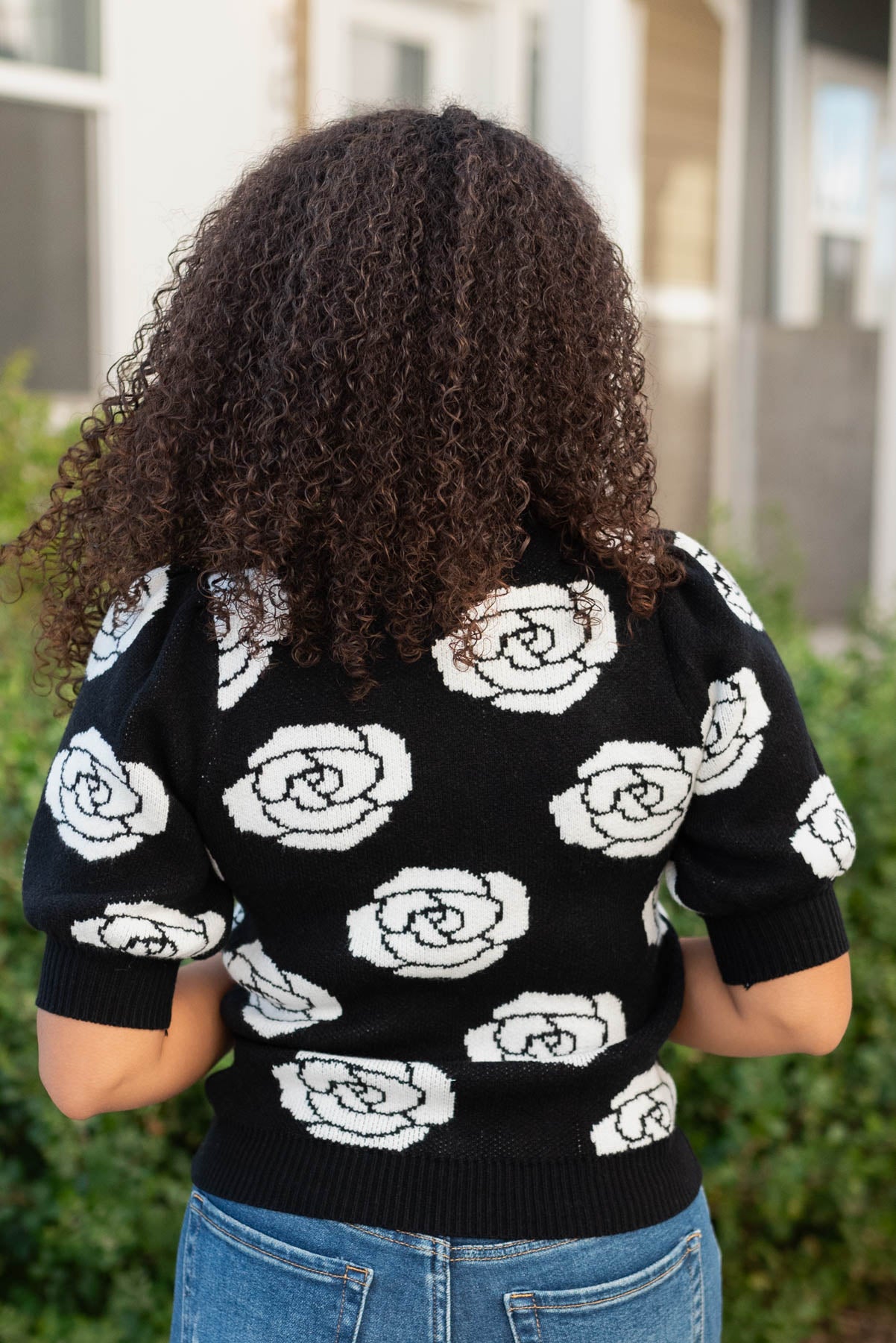 Back view of the black floral print sweater