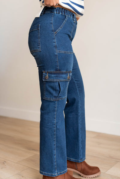 Side view of the dark denim cargo jeans with elastic waist