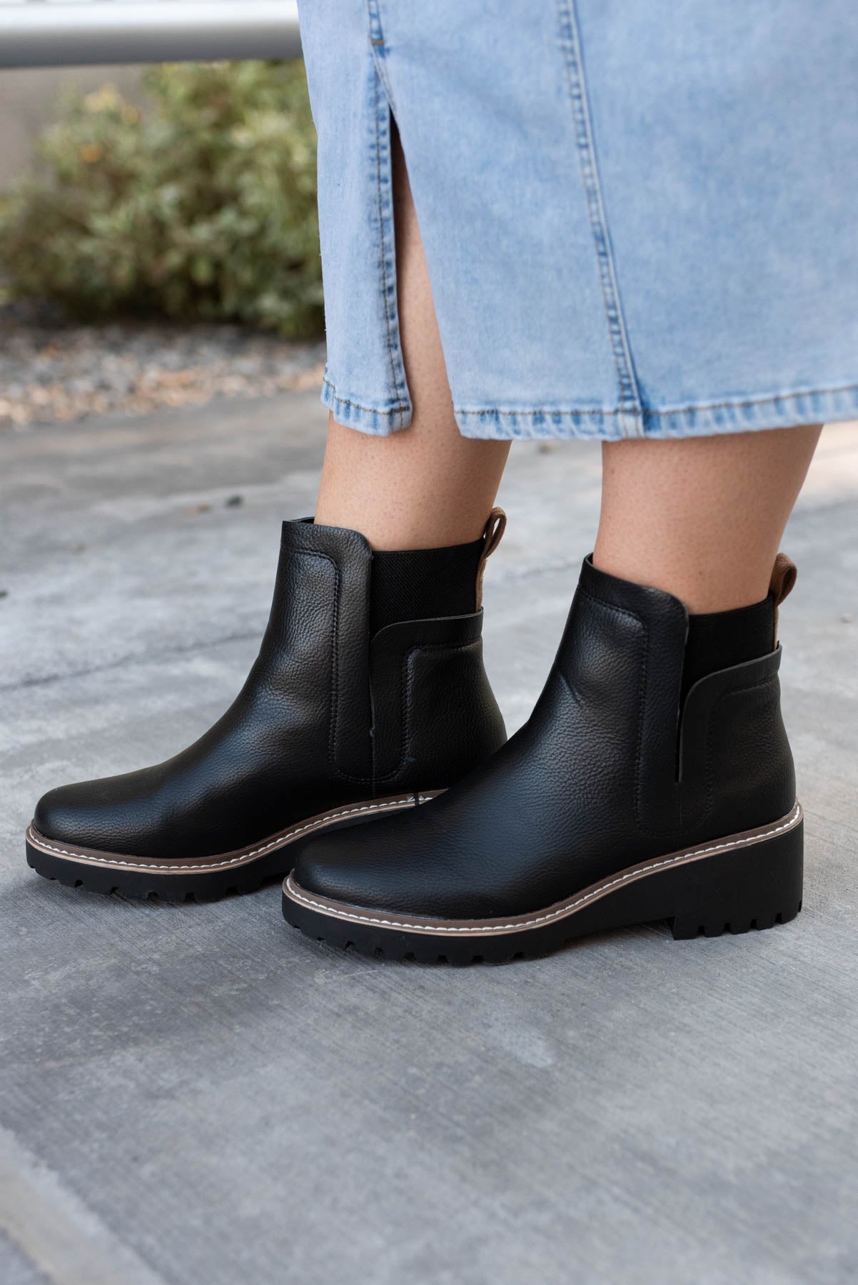 Black ankle boots with tan and white stitching