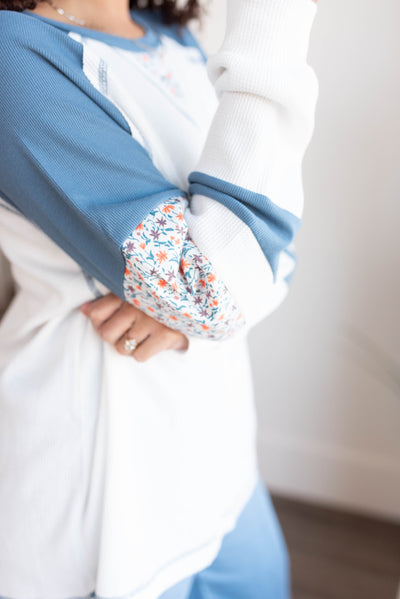 Close up of the sleeve on the blue floral patchwork long sleeve top