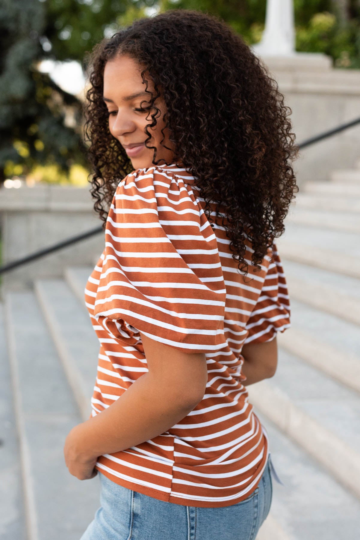 Side view of the terracotta stripe puff sleeve top