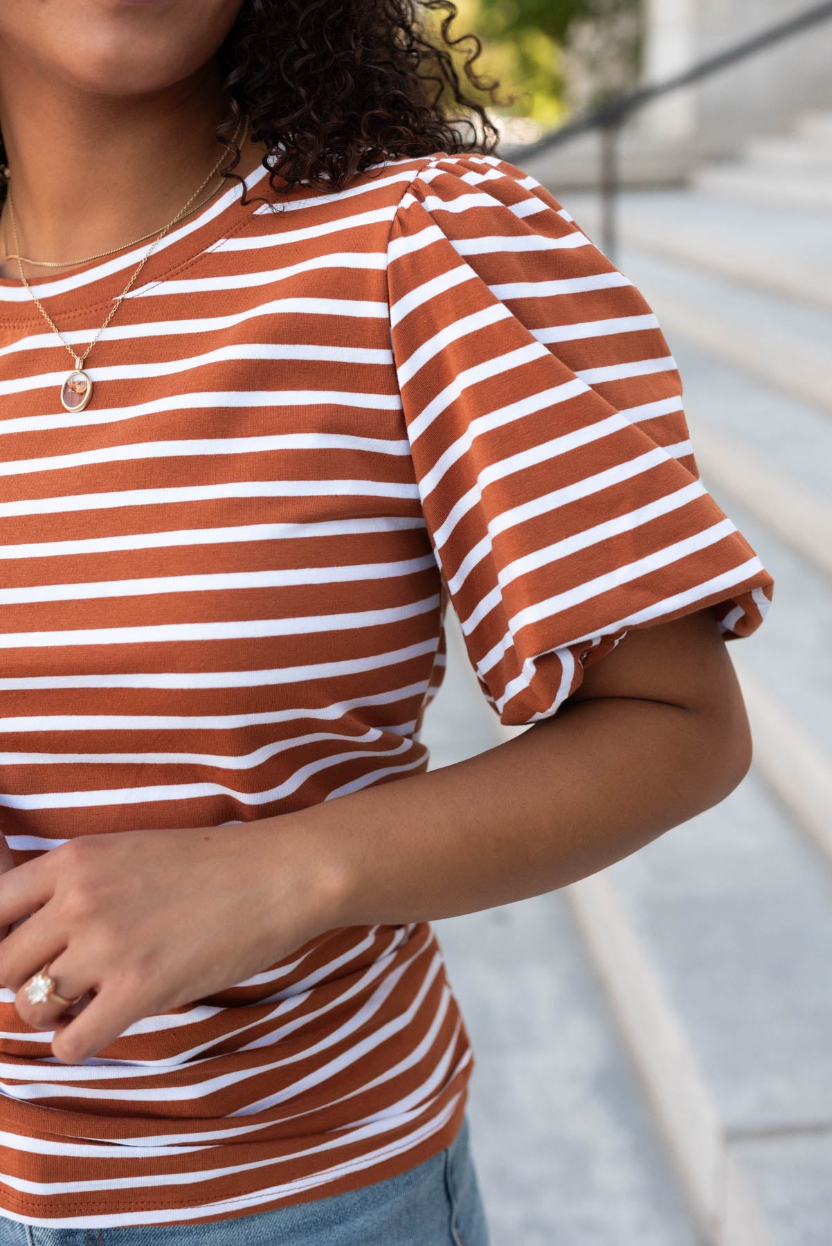 Close up of the sleeve on the terracotta stripe puff sleeve top