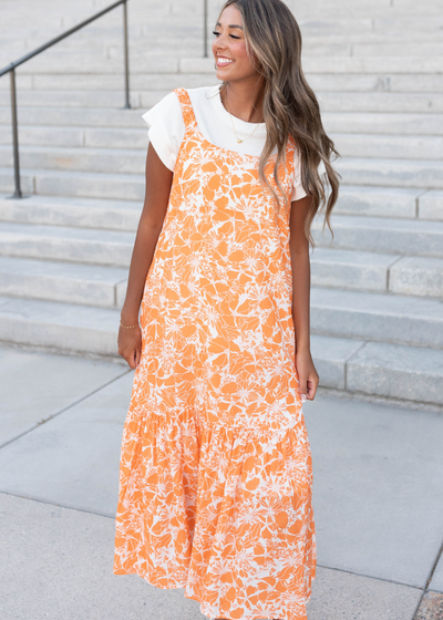 Front view of the orange floral strap dress