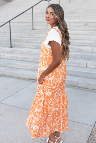 Side view of the orange floral strap dress