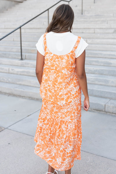 Back view of the orange floral strap dress