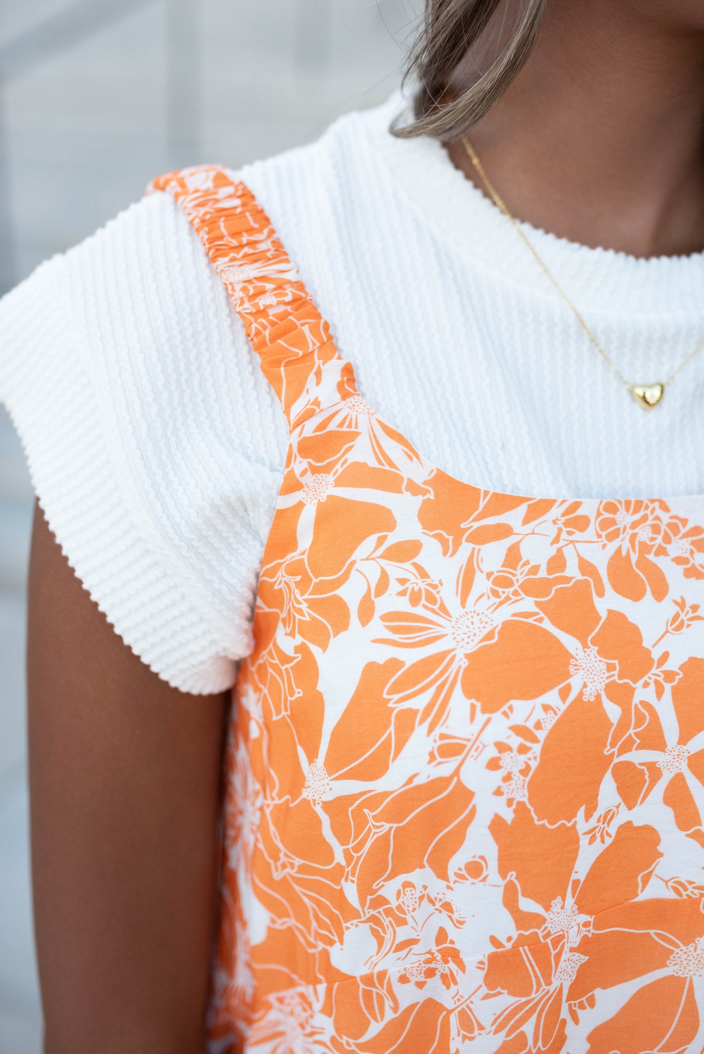 Close up of the straps and fabric on the orange floral strap dress