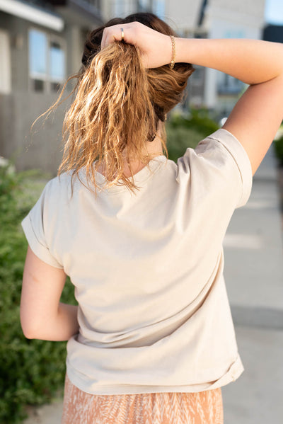 Back view of the sand beige folded sleeve top