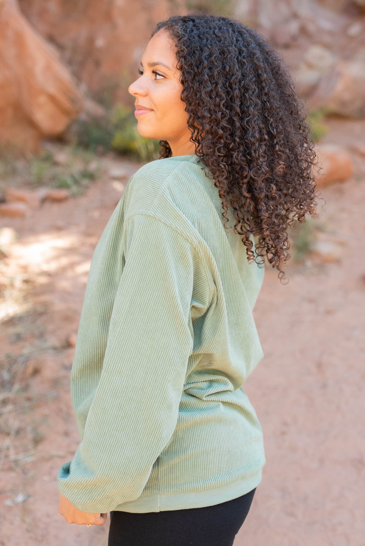 Side view of the green ribbed sweatershirt