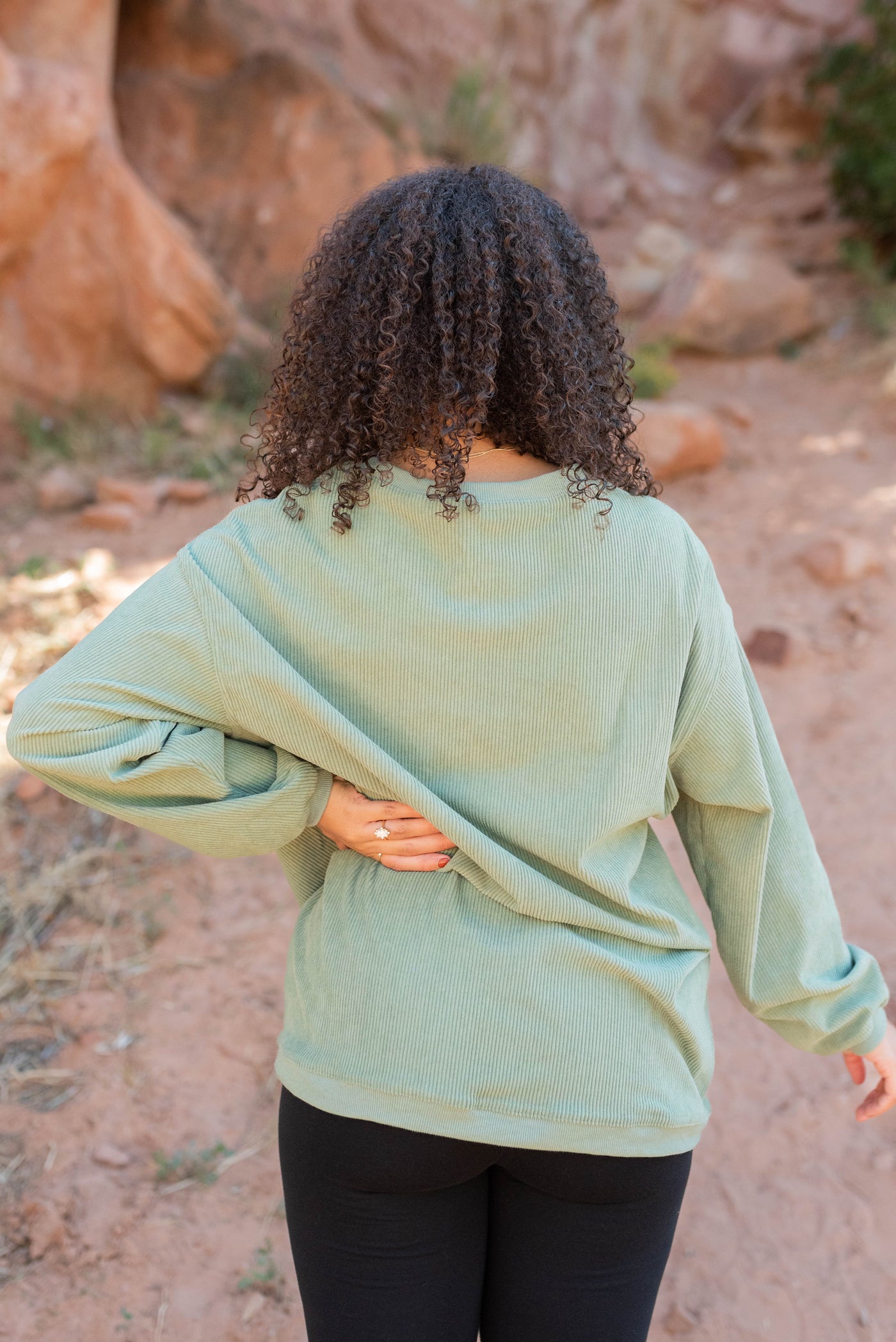 Back view of the green ribbed sweatershirt