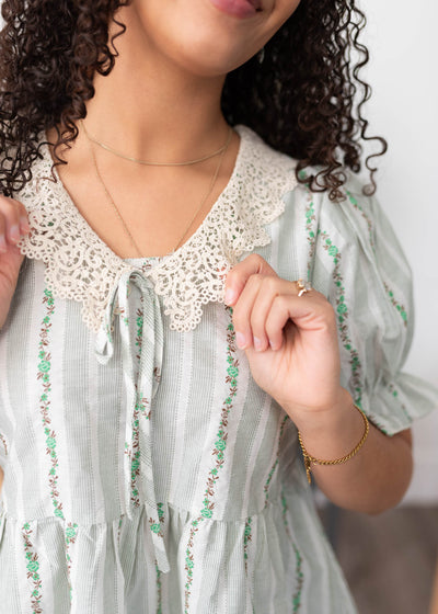 Green lace top with a neck and tie