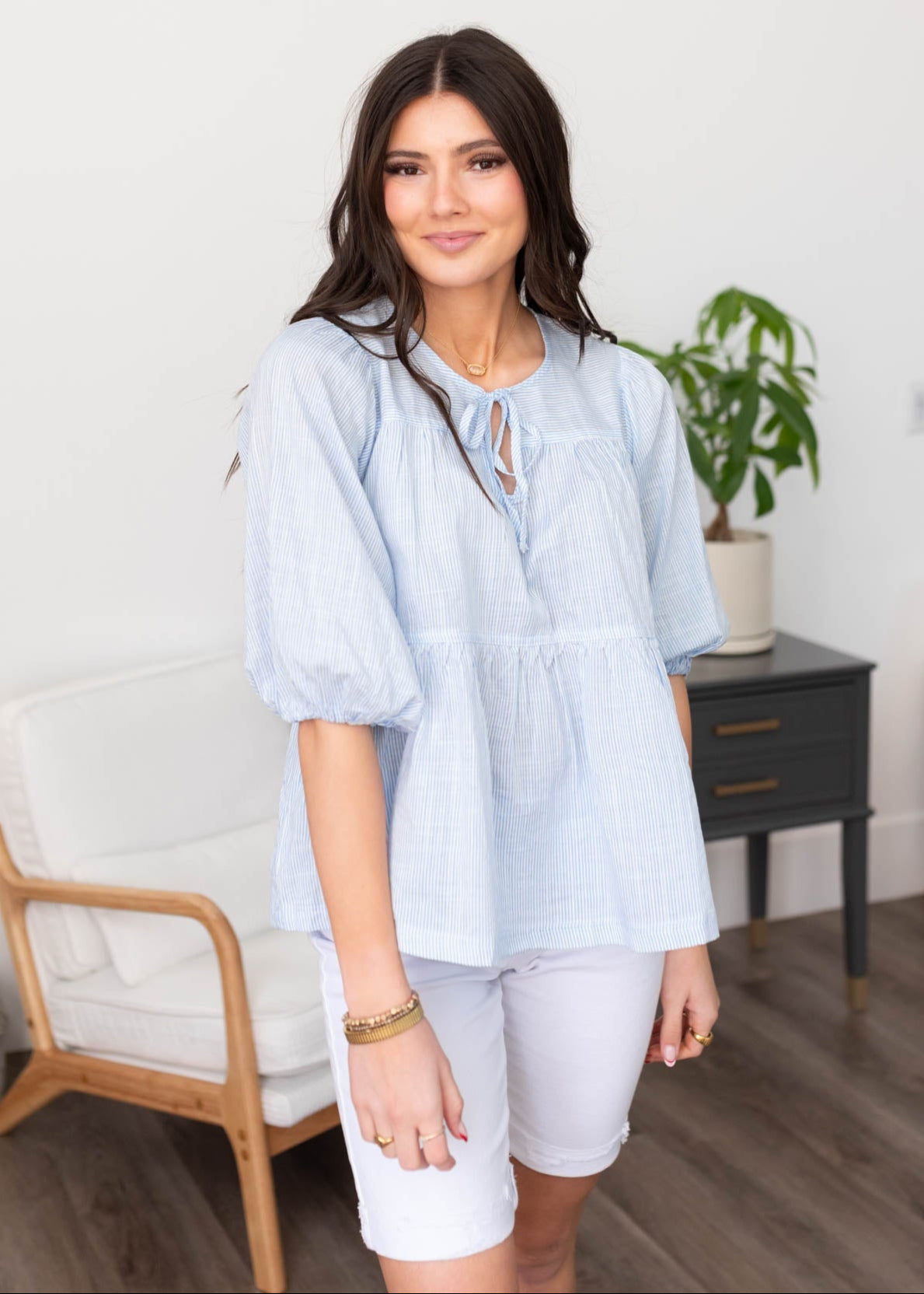 LIght blue striped top with a peplum style