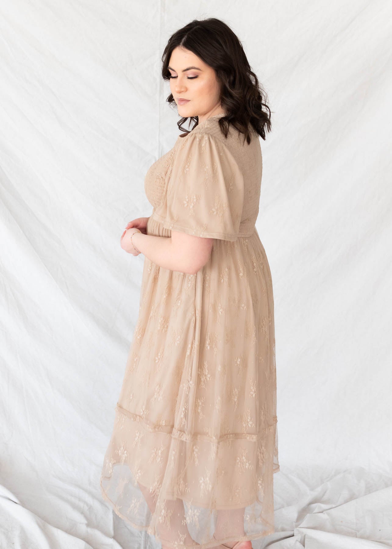 Side view of the plus size beige smocked lace dress