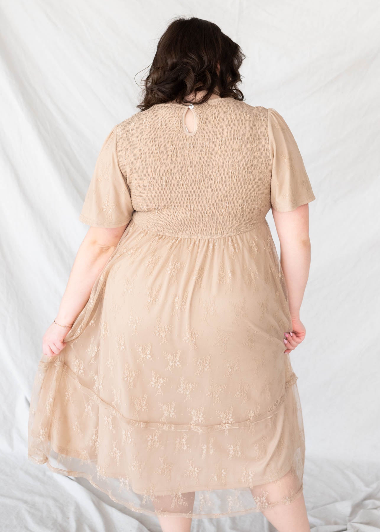 Back view of the beige smocked lace dress in plus size