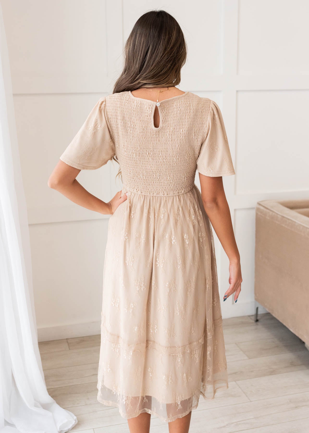 Back view of the beige smocked lace dress