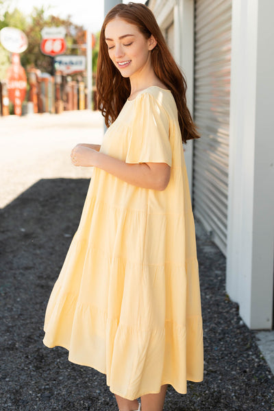 Side view of the light yellow tiered dress