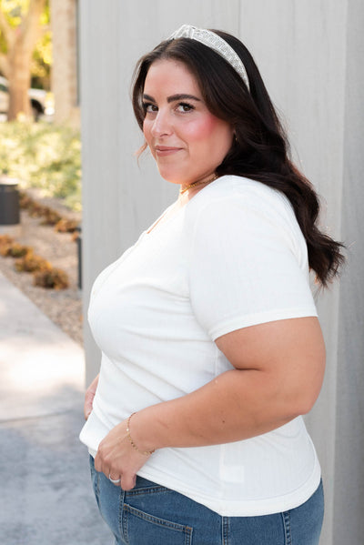 Side view of the plus size ivory ribbed top