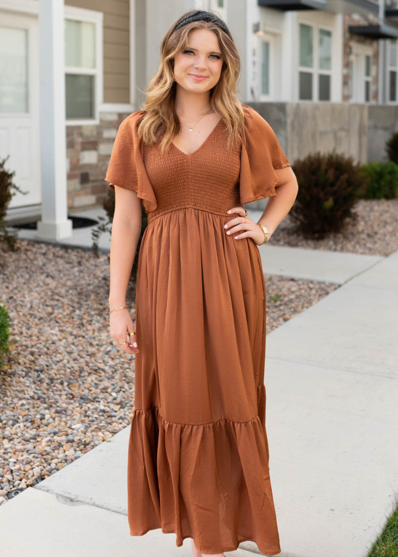 Front view of the sepia satin dress with a smocked bodice