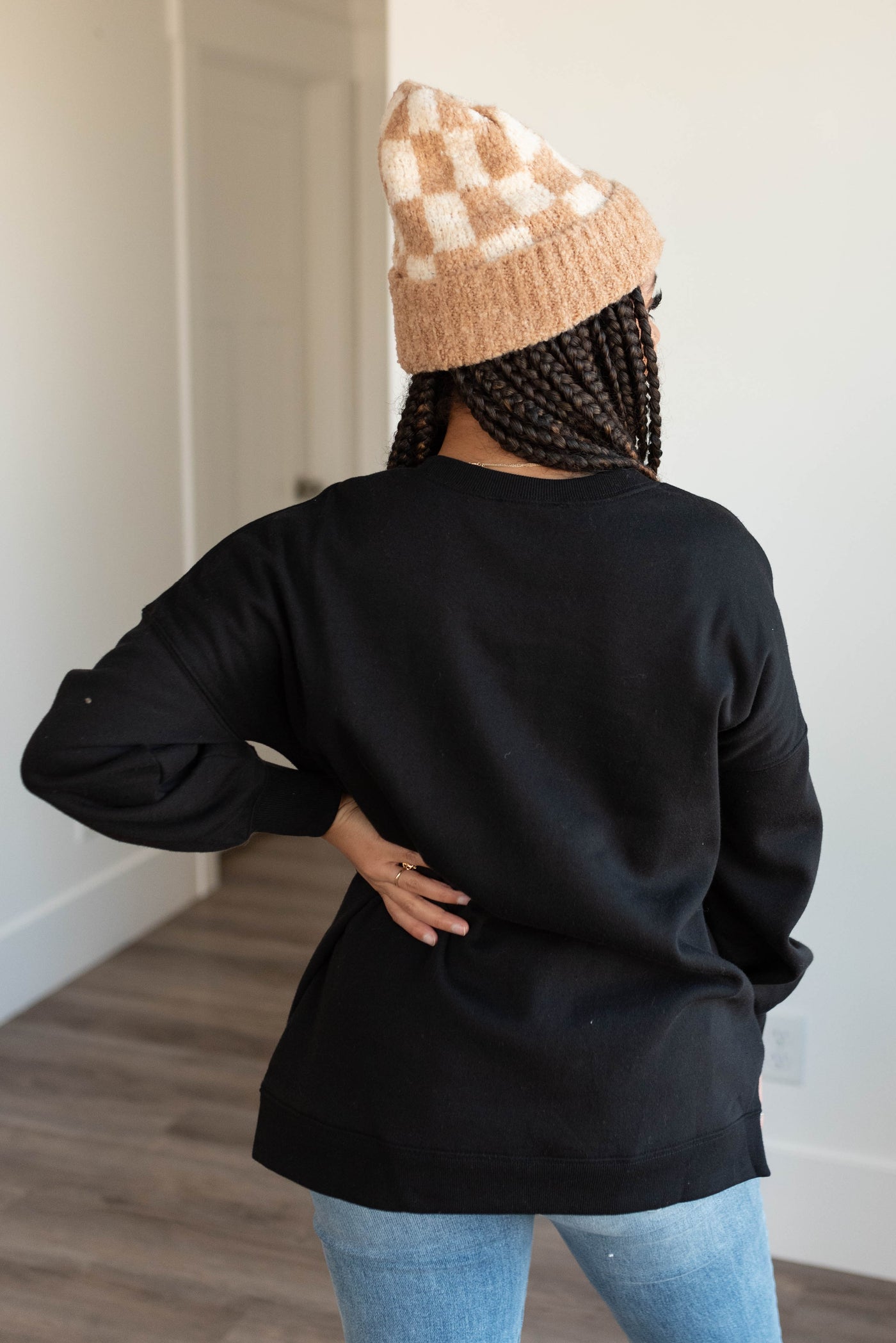 Back view of the black pocketed sweater