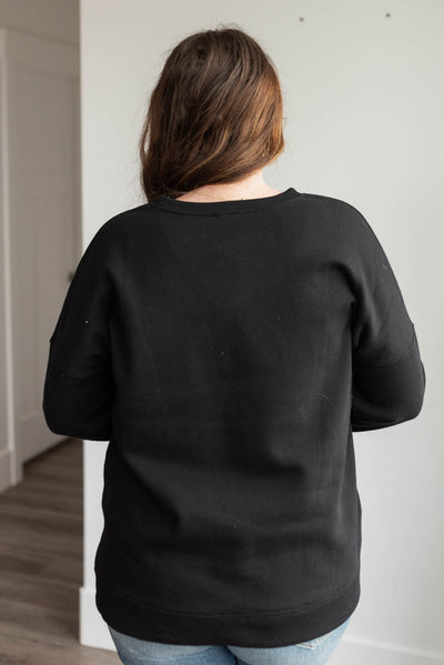 Back view of the plus size black pocketed sweater