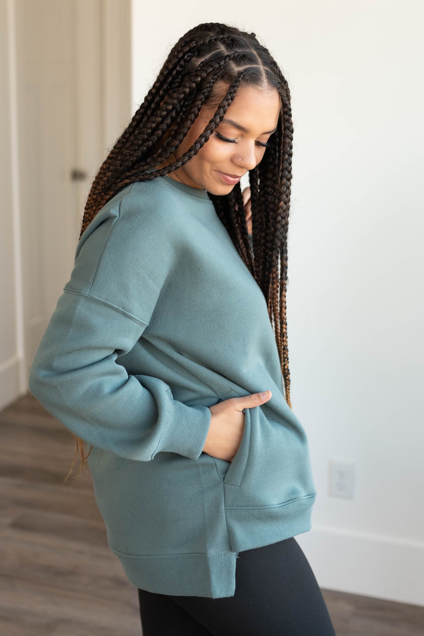 Side view of the jade pocketed sweater with pockets on the side