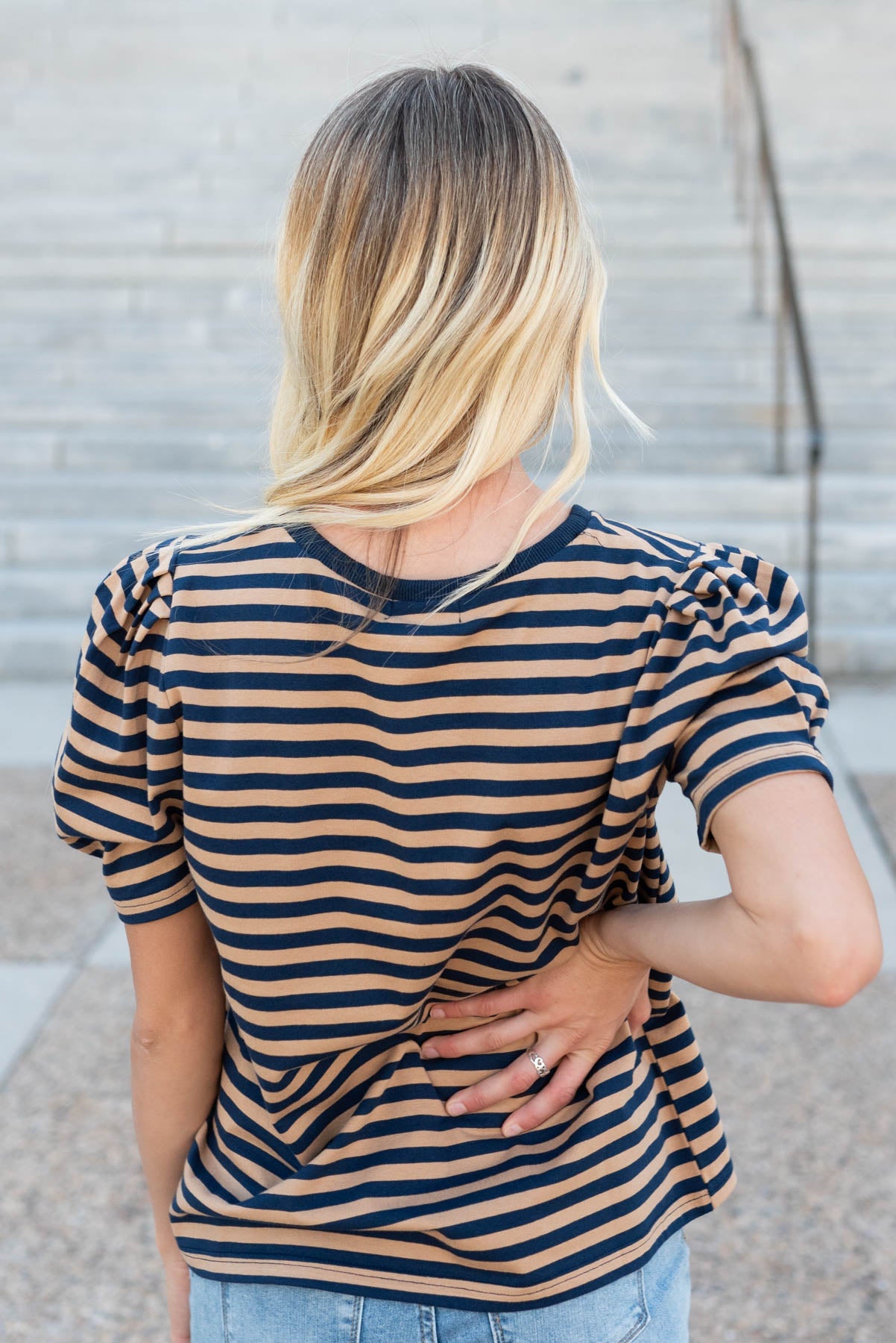 Back view of the navy camel stripe top