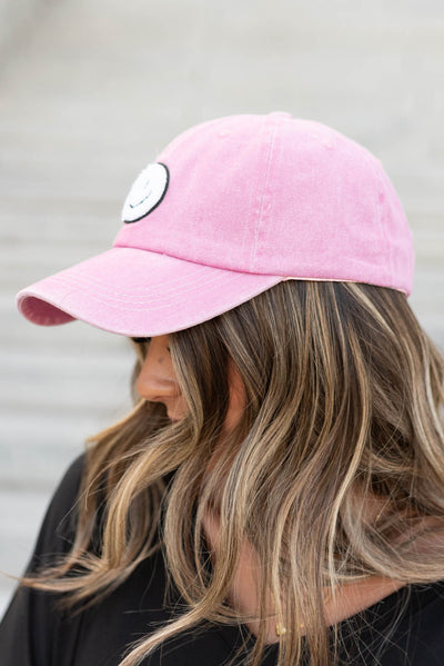 Side view of the pink sherpa happy face hat