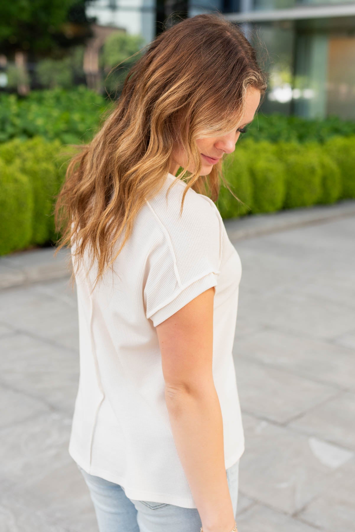 Side view of the cream waffle knit top