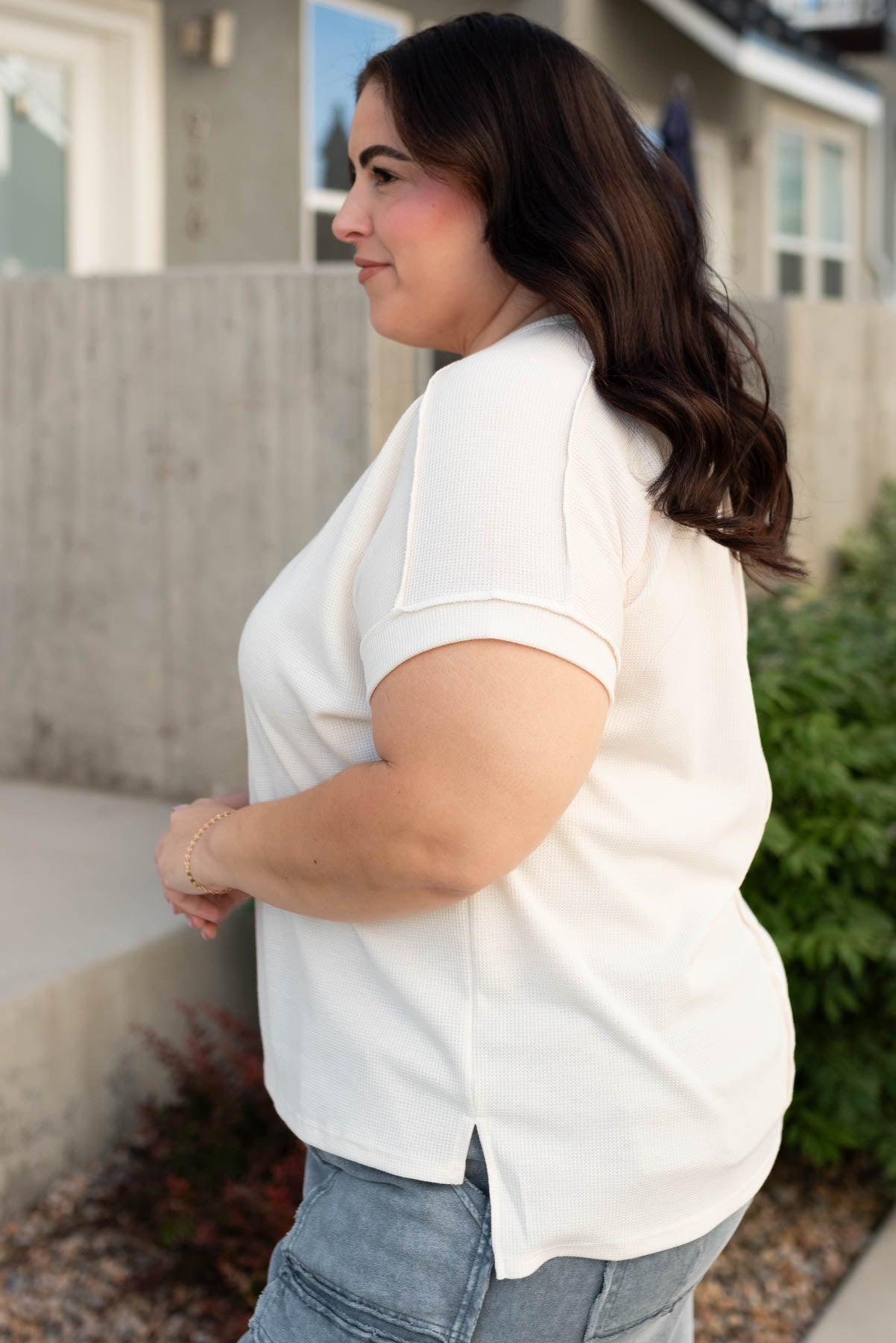 Side view of the plus size cream waffle knit top