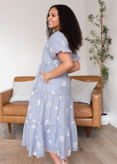 Side view of the dusty blue embroidered dress