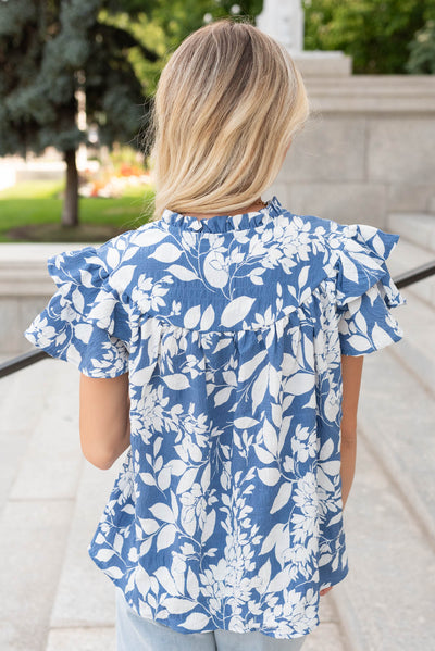 Back view of the blue floral ruffle top