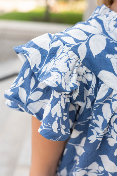 Close up of the blue floral ruffle top sleeve and fabric