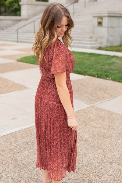 Side view of the burgundy pleated tie dress