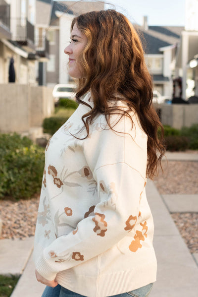 Side view of theoatmeal floral sweater