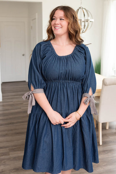 Front view of the plus size dark denim tiered dress