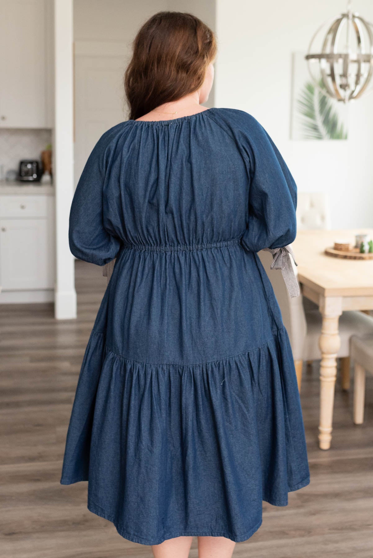 Back view of the plus size dark denim tiered dress