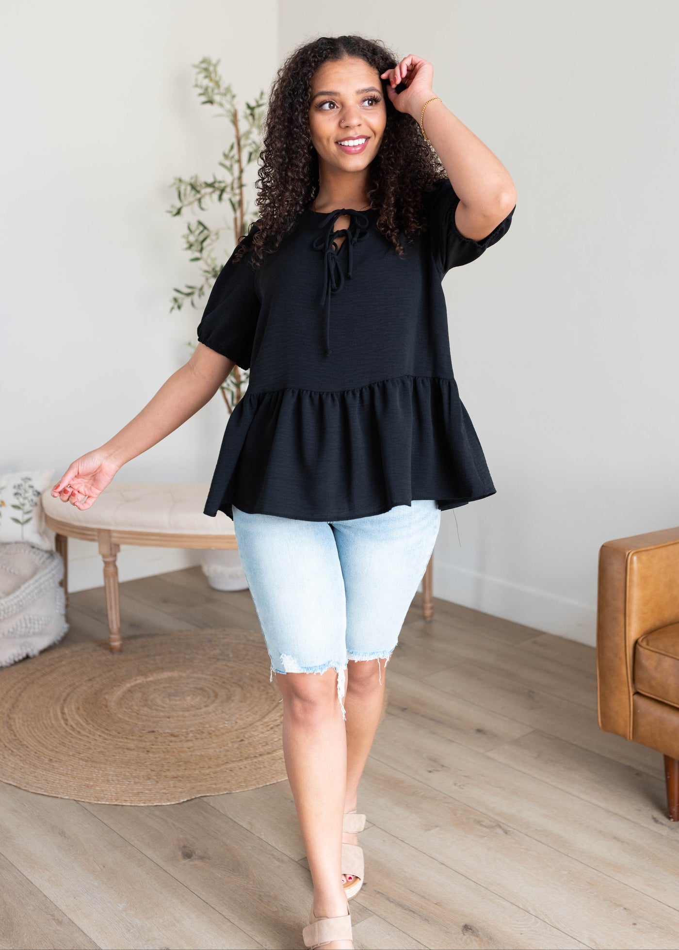 Black tiered blouse with a peplum style