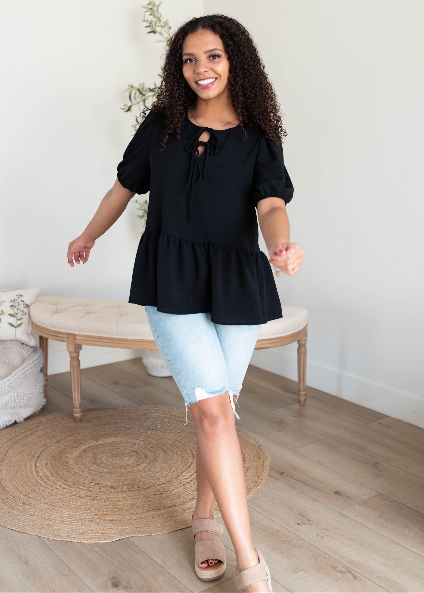 Black tiered blouse with bows at the top