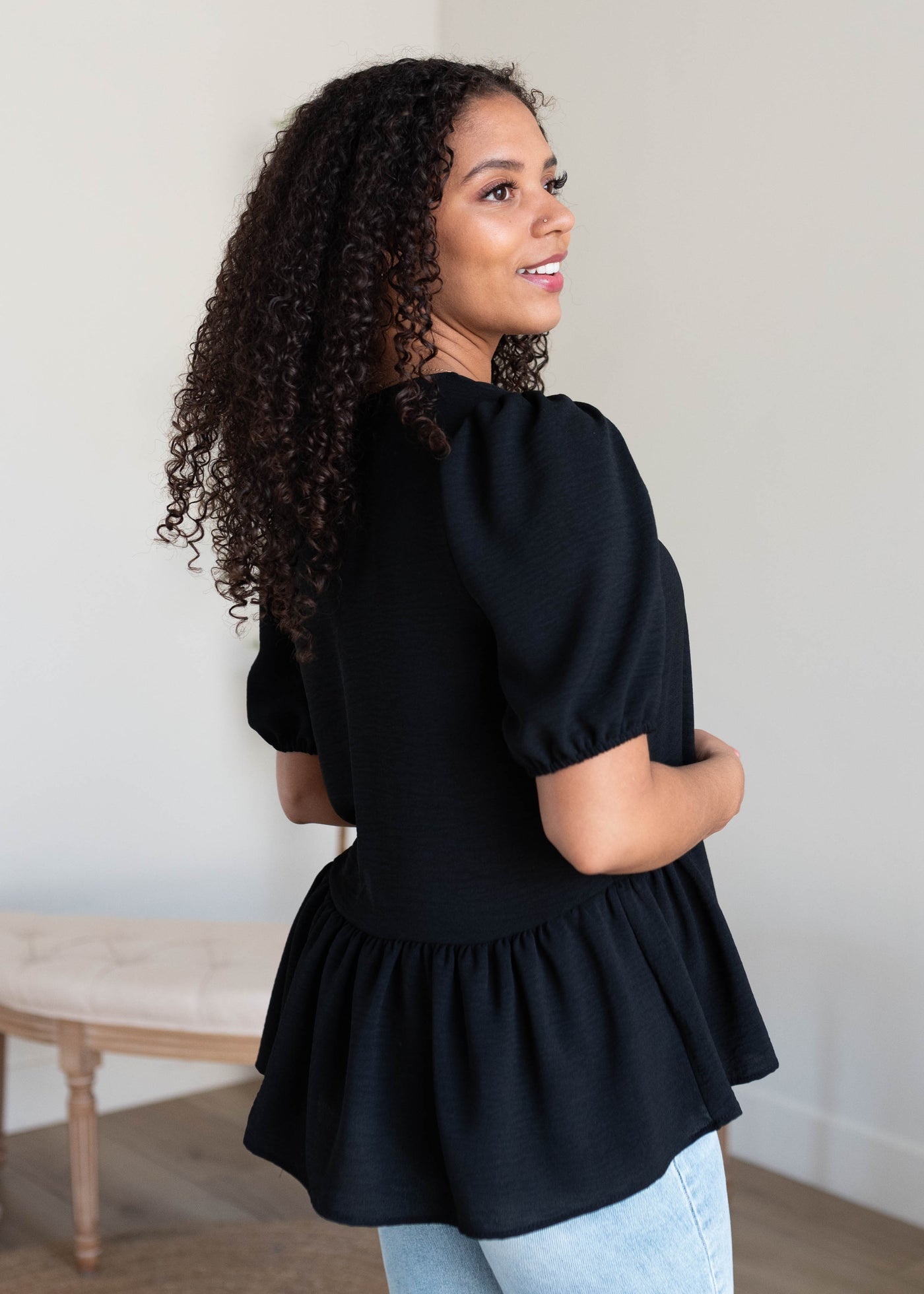 Side view of the black tiered blouse