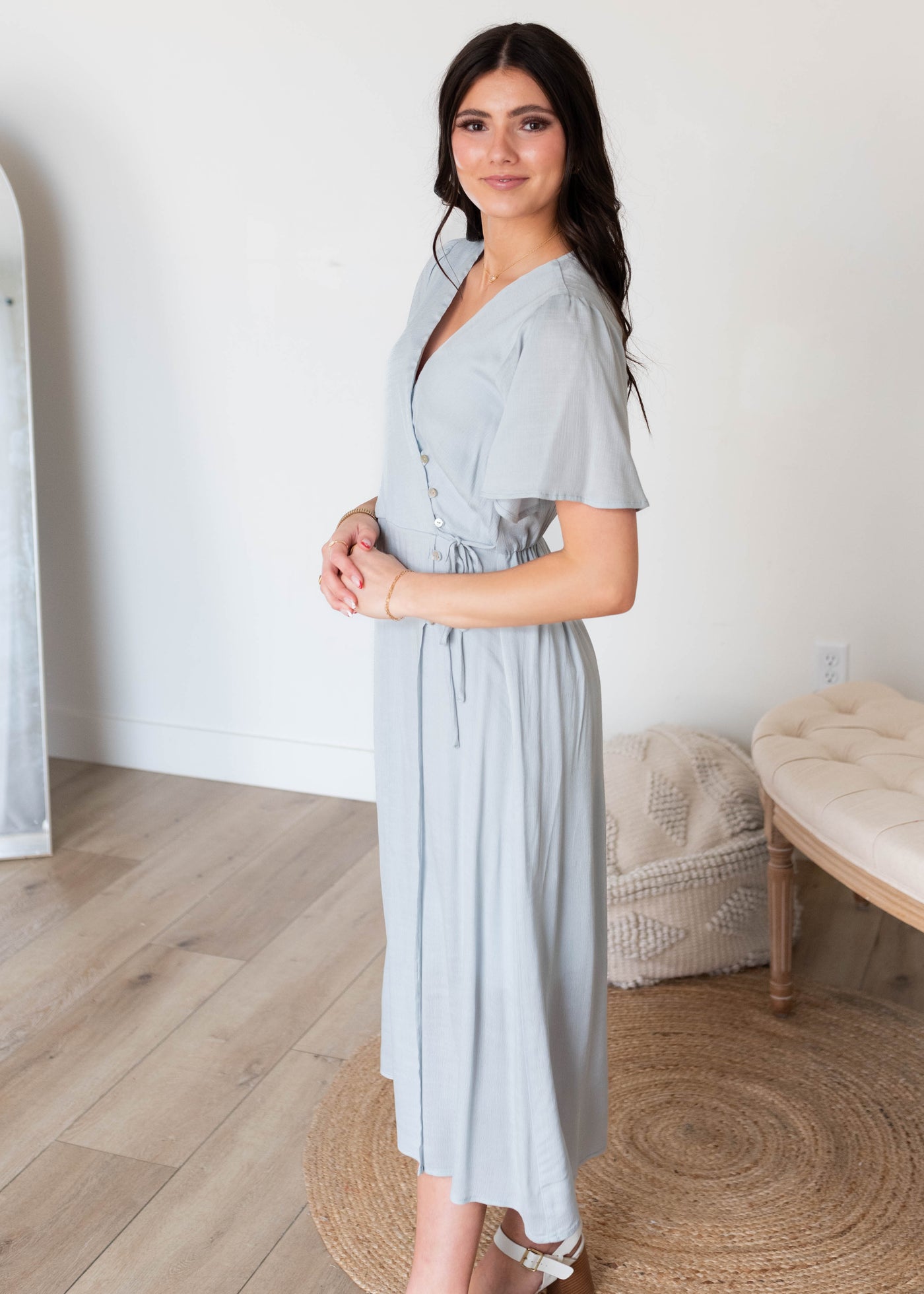 Side view of the dusty blue wrap dress