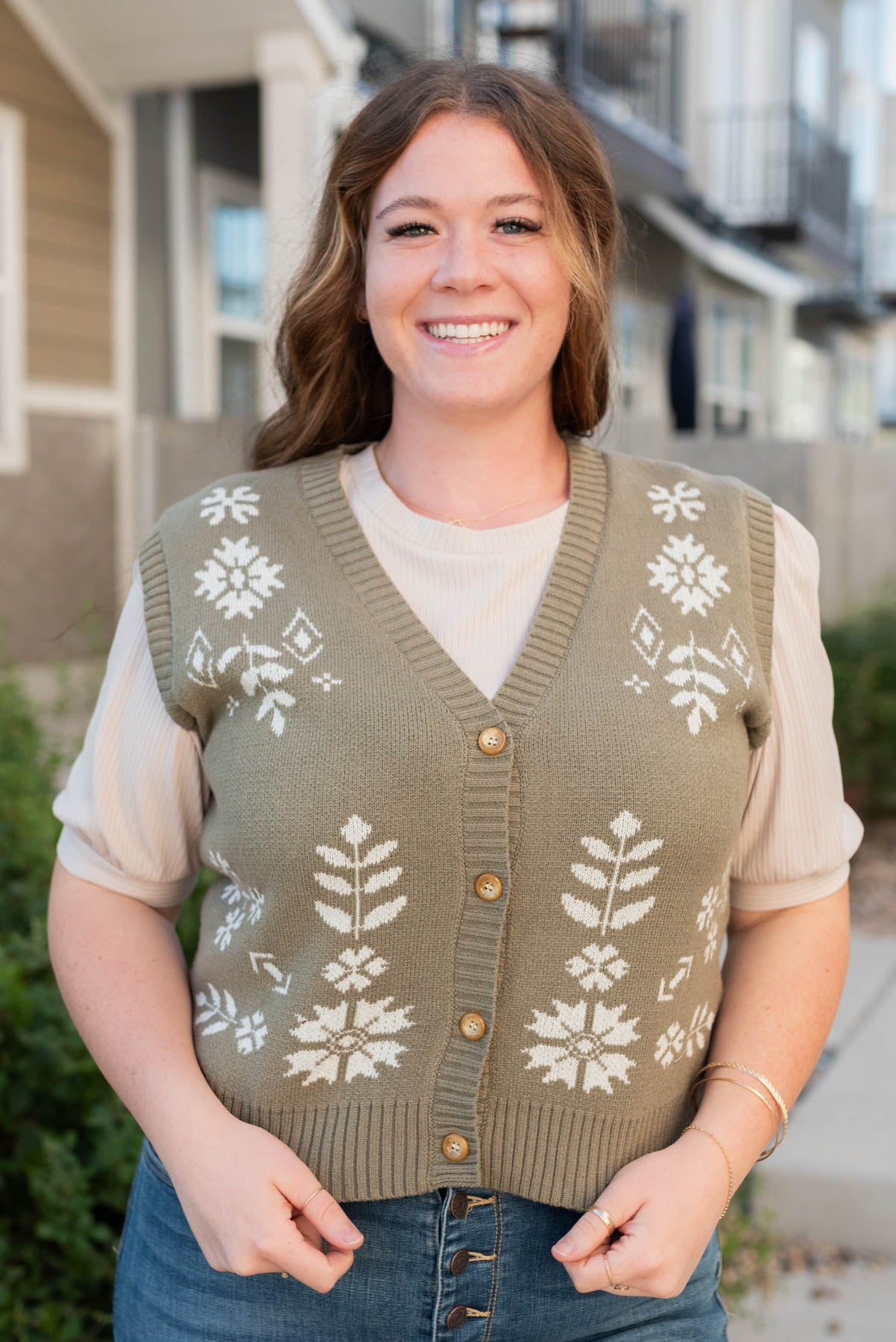 Front view of the light olive floral sweater vest