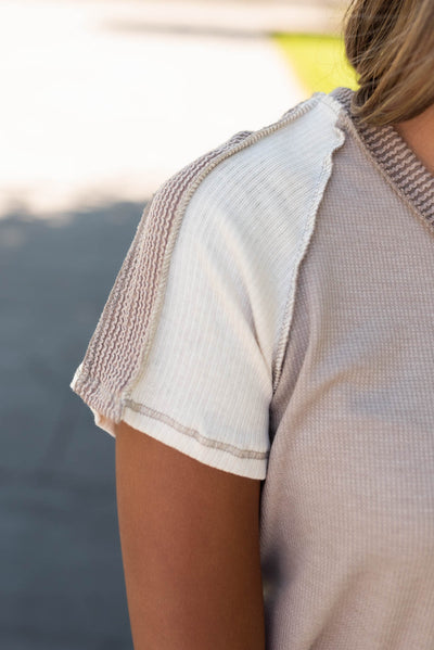 Close up of the ivory sleeve on the mocha ribbed top