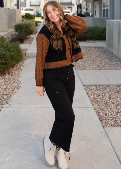 Black knit cardigan with rust sleeves