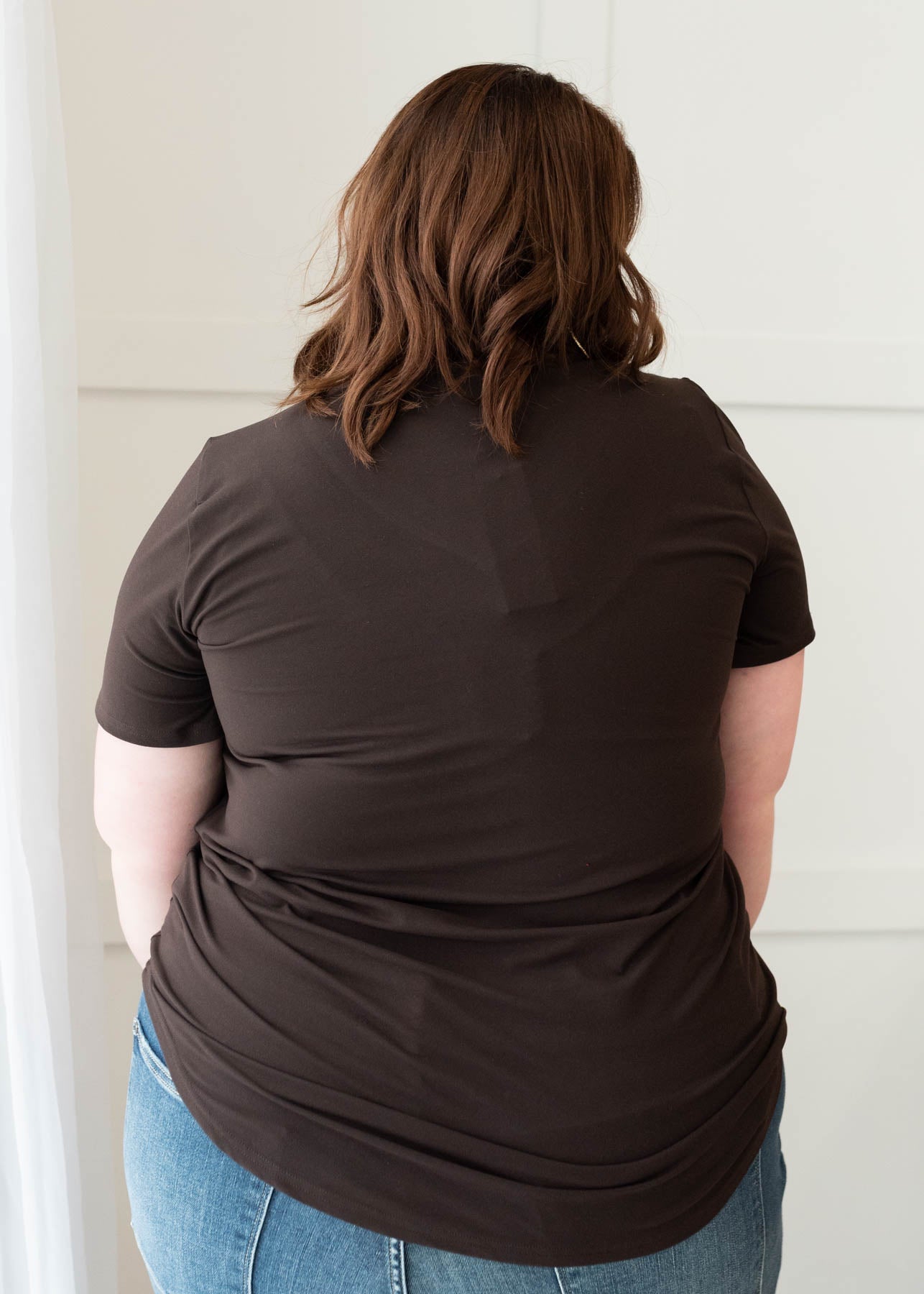 Back view of the plus size classic brown v-neck top