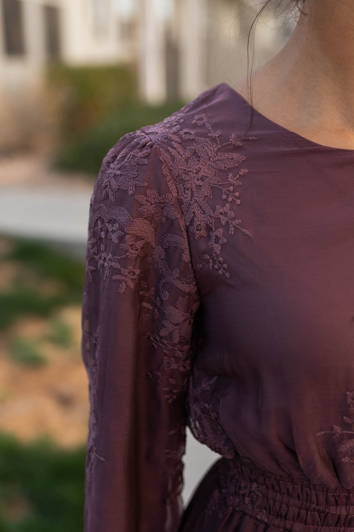 Close up of the embroidery on the fabric of the dusty plum embroidered chiffon dress