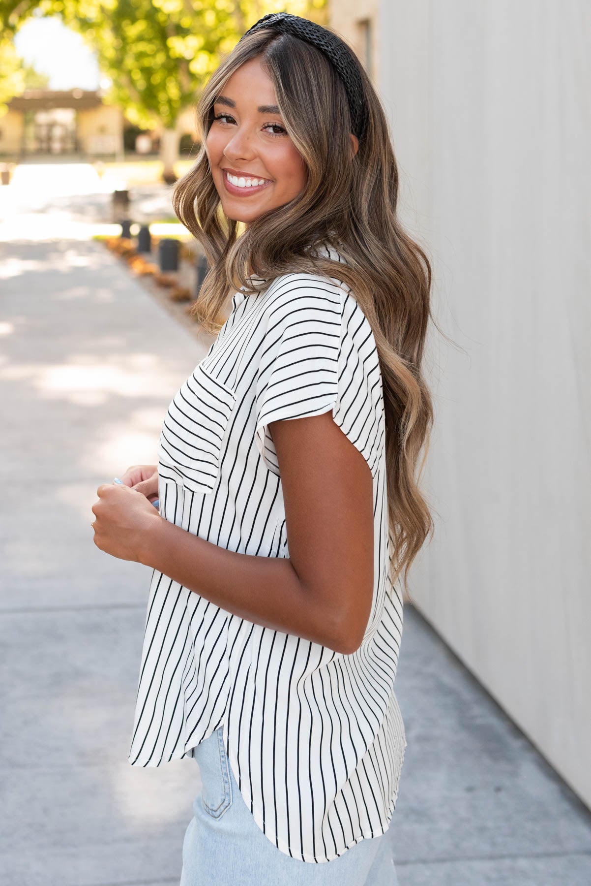 Side view of the white black stripe top