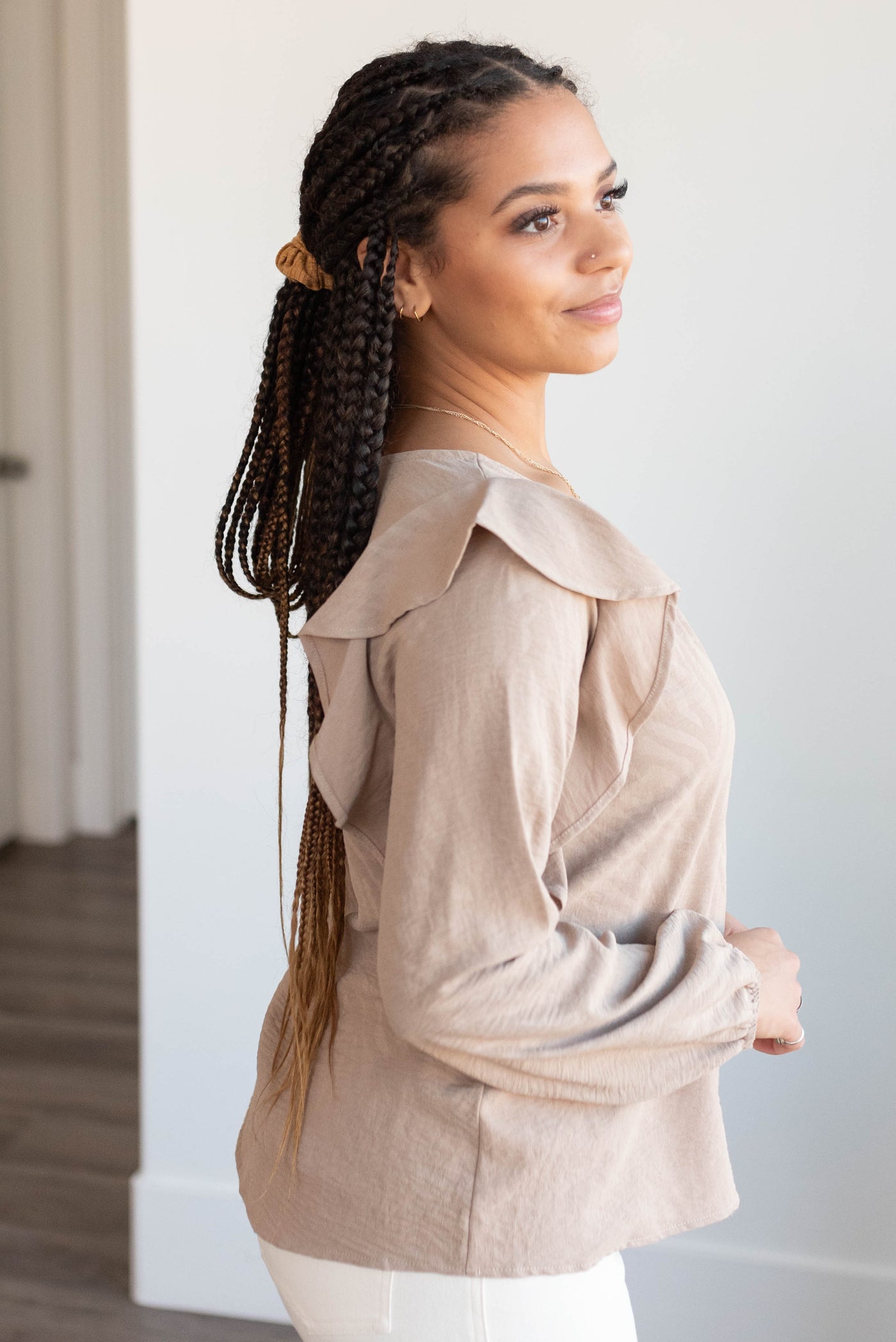 Side view of the beige long sleeve top